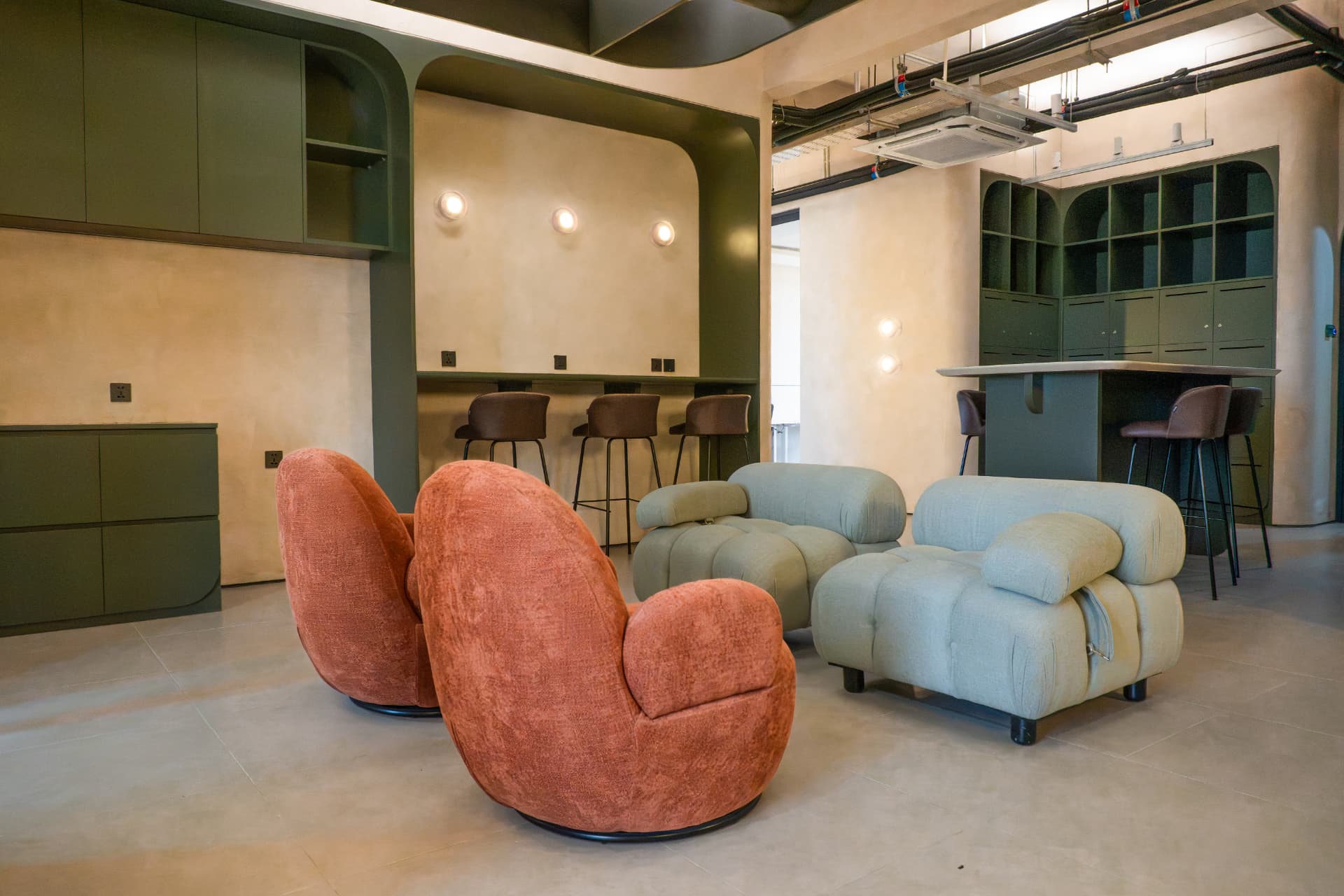 The member lounge at Argil in Pererenan, with sofas, plants and a long communal table